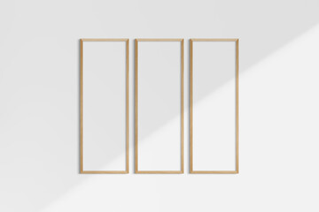 Frame mockup 1:3. Set of three thin cherry wood frames. Gallery wall mockup, set of 3 frames. Clean, modern, minimalist, bright. Portrait. Vertical. Shadow overlay.