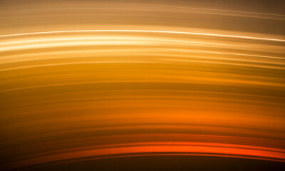 Horizontal bands of glowing orange and yellow light create a warm, abstract background amber blur
