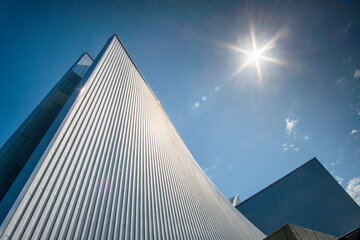 View of the striking, sun-drenched architecture of Saint Mary's Cathedral against the deep blue sky, creating a powerful visual contrast, Tokyo, Japan.
