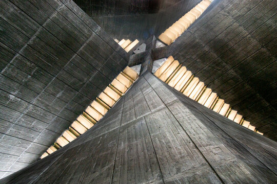 View of the dramatic, textured concrete interior converging upwards to a bright, geometric skylight in Saint Mary's Cathedral, Tokyo, Japan.