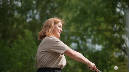 Caucasian Woman Plays Table Tennis, Female Player In Summer Setting Performing Dynamic Forehand Shot, Woman In Outdoor Environment Strikes Ball With Force During Competitive Tennis Match