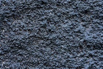 Obraz premium Abstract Dark Black and Navy Blue Gritty Wall Texture Background with Coarse Rough Surface, Industrial or Grunge Background: Seamless Pattern of Rough, Bumpy, and Weathered Texture