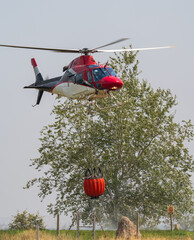 Helicopter in Action with Firefighting Water Bucket