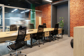 Modern office workspace with brick walls and sleek furniture during the day