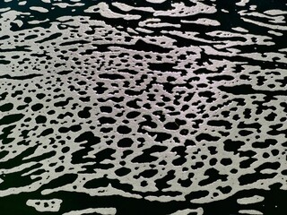 abstract pattern with waves of green water and white foam