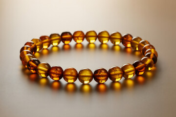 Golden amber bracelet on light background