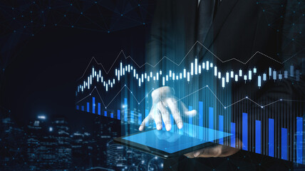A businessman interacts with a digital tablet displaying dynamic financial graphs, symbolizing data analysis and strategic decision-making in a modern corporate setting. Scalp