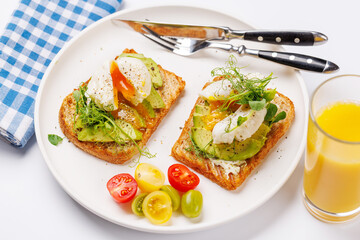 Delicious avocado toasts topped with perfectly cooked poached eggs