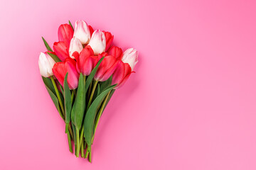 Pink and white tulip bouquet on a soft pink background