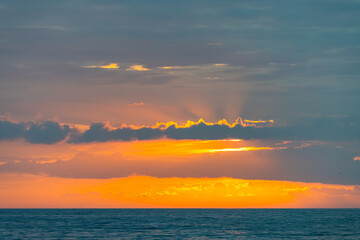Seaside Sunrise with Clouds above  and Crepscular rays