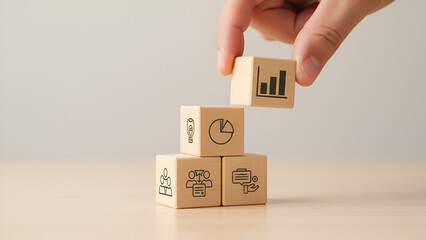 Growth and Strategy: Hand Stacking Wooden Blocks with Business Icons

