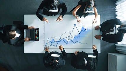 A business team engaged in data analysis using virtual reality technology in a contemporary office setting, exploring strategies for growth and innovation. Scalp