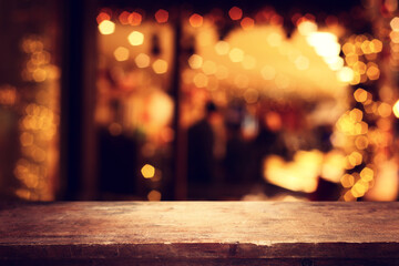 Wooden table and lights during night time. Product display or mockup
