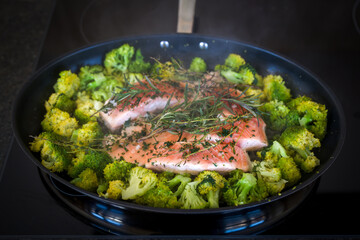 fresh and healthy cooking at home - roasted salmon with broccoli and herbs