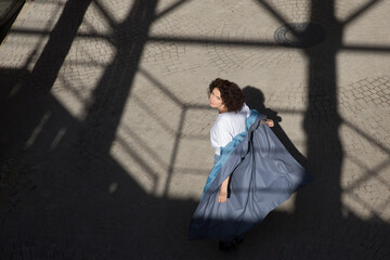 middle aged woman walks on the street of the  city. copy space. Slow life. Enjoying the little things. spends time in nature in summer