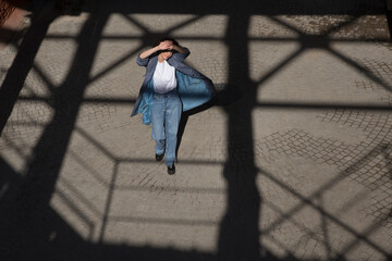 middle aged woman walks on the street of the  city. copy space. Slow life. Enjoying the little things. spends time in nature in summer