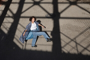 middle aged woman walks on the street of the  city. copy space. Slow life. Enjoying the little things. spends time in nature in summer