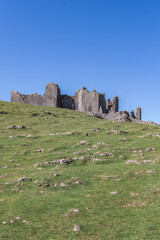 The ruin of Carreg Cennen Castle sited on a high rocky outcrop in Carmarthenshire, Wales on a sunny day
