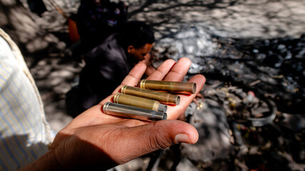 Bullet casings in hand used by the Datoga for crafting