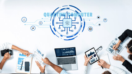 Professionals collaborate on a quantum computing project, utilizing modern devices for data analysis while surrounded by visuals, showcasing innovation and teamwork. Trope