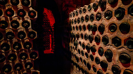 Wine bottles stored in dimly lit cellar