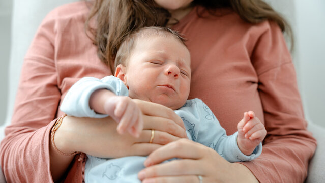 Newborn resting in mother's comforting arms
