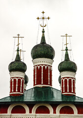 ornate domes of a traditional Russian Orthodox church. Onion-shaped green domes with intricate detailing and golden crosses. Russian religious architecture. For  cultural, religious articles