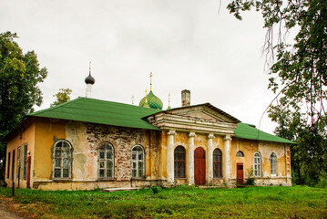 old, weathered building. A house with classical facade featuring columns and arched windows. Ideal for use in historical, or architectural stock collections