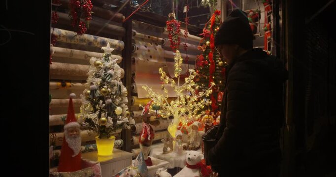 Woman looking at Christmas offers at a store