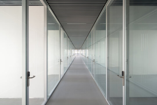 Minimalist corridor with glass partitions in modern campus