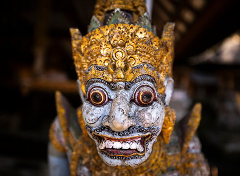 Detailed Balinese sculpture with golden accents