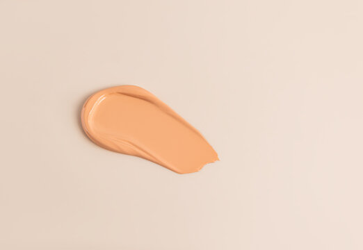 Foundation sample in neutral tone on light background