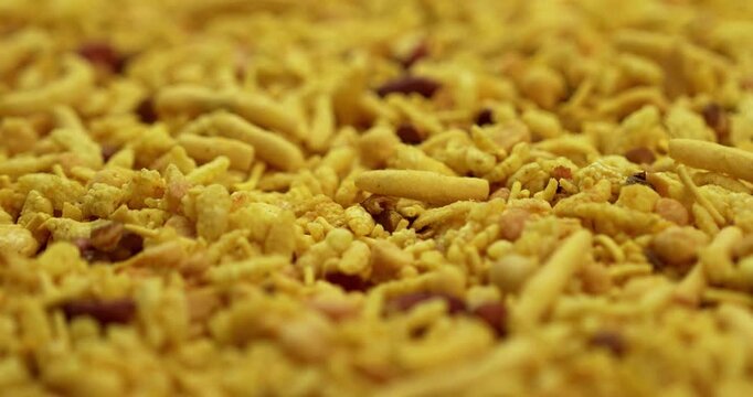 Traditional indian deep fried salty dish - chivda or farsan or namkeen made of gram flour and mixed with dry fruits, selective focus