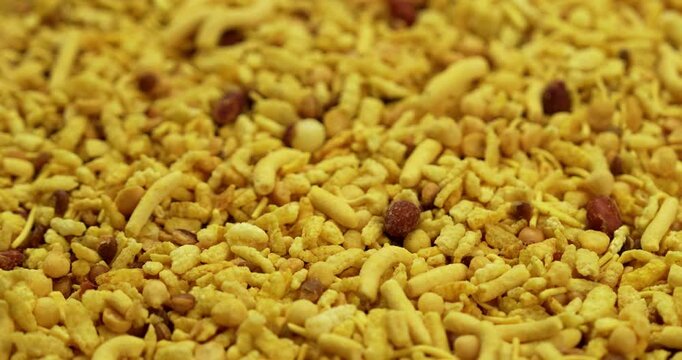Traditional indian deep fried salty dish - chivda or farsan or namkeen made of gram flour and mixed with dry fruits, selective focus
