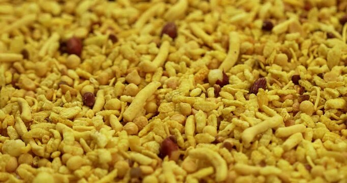 Traditional indian deep fried salty dish - chivda or farsan or namkeen made of gram flour and mixed with dry fruits, selective focus