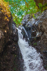 Gushing water of scenic Tululusia Waterfall in Arusha National Park
