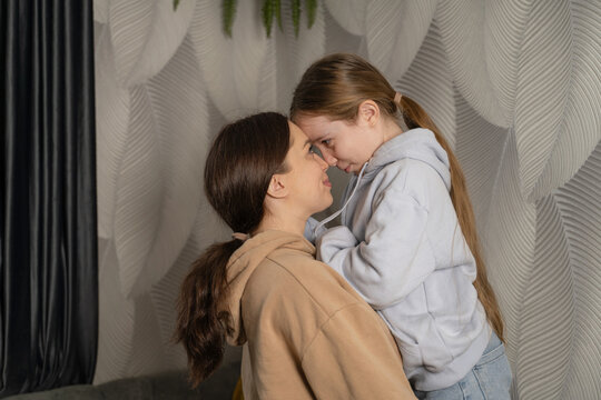 Mother and daughter bonding at home in cozy setting