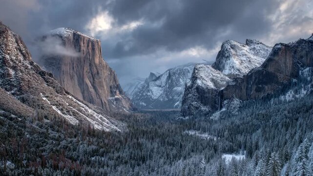 Ultra HD Dramatic winter view of yosemite valley with el capitan and snowcovered mountains under dark clouds video
