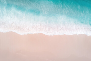 Close-Up Aerial View of Ocean Waves Reaching Sandy Beach