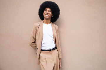Person in stylish brown blazer with cheerful expression