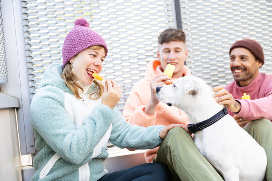 Friends enjoy popsicles in an urban autumn setting