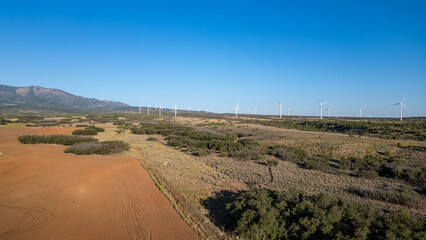 Naklejka premium A large field of wind turbines is visible in the distance