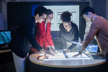 Diverse team of developers and designers having project discussion and strategy meeting. Reviewing digital data, brainstorming UX UI and web design for application development. Startup teamwork