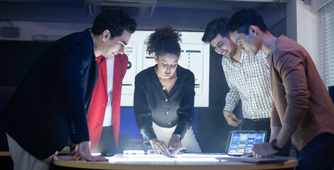 Diverse team of developers and designers having project discussion and strategy meeting. Reviewing digital data, brainstorming UX UI and web design for application development. Startup teamwork