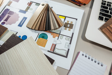 Laptop with color palette and wood samples on architect desk, interior renovation and design project