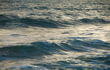 Waves on the ocean at sunrise. Water, waves  background