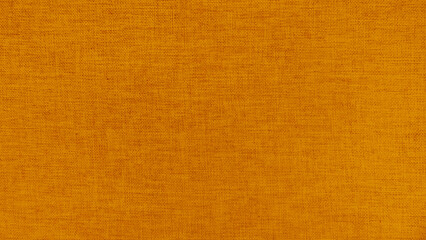 gold yellow linen fabric texture background. High resolution close up of natural woven textile surface. yellow canvas material pattern for abstract wallpaper or furniture upholstery design.