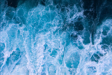 Atlantic Ocean waves breaking with white foam during stormy weather, top view