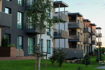 New modern apartment building exteriors in a residential area, with balconies and contemporary architecture.