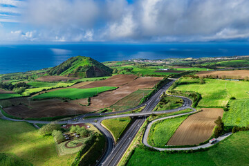 Aerial view of highway system and overpass surrounded by agricultural fields, Sao Miguel Island,...